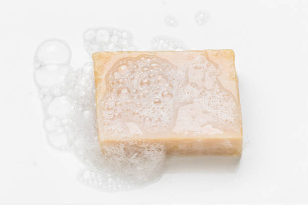istock Soap bar and foam on white background 1289049164