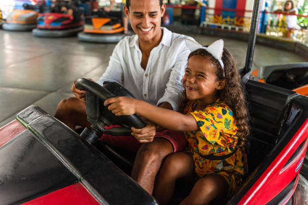 istock Father and daughter enjoying bumper car ride 1289049227