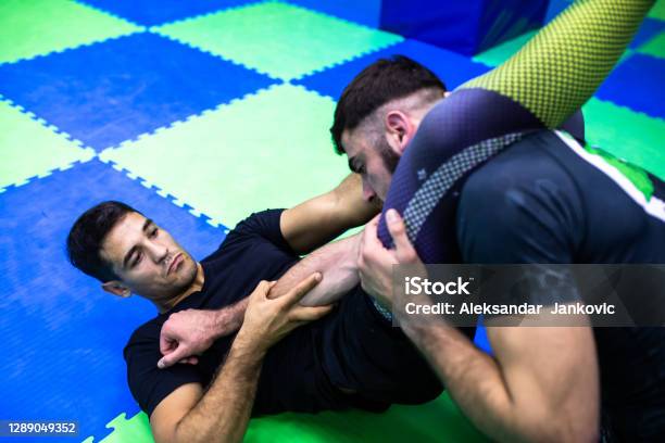 Combat Sports Athletes Working On Their Technique Stock Photo - Download Image Now - Brazilian Jiu-Jitsu, 20-24 Years, 25-29 Years