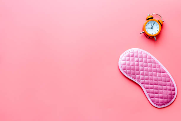 istock Insomnia concept. Sleep eye mask and alarm clock, top view 1289051018