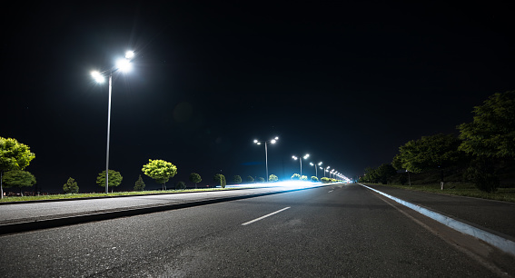 empty asphalt road and street lights at night background