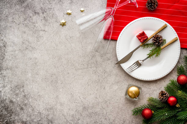 istock Frame of Christmas table setting with fir tree and empty plate, top view 1289053136