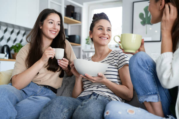 istock Three happy friends chatting and eating popcorn 1289055641