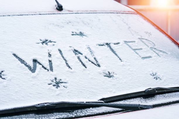 istock word Winter written with finger on a snowy windshield of a car 1289059643