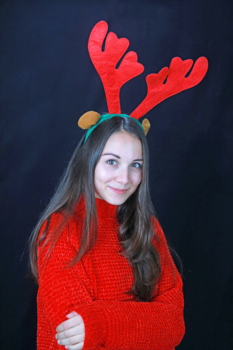 A pretty woman dressed as a reindeer during the Christmas season.