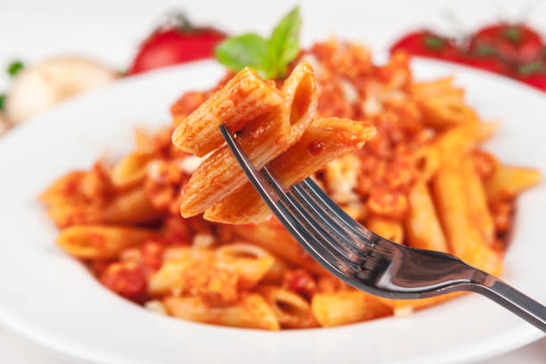 istock Pasta with meat, tomato sauce and vegetables on the table 1289060362