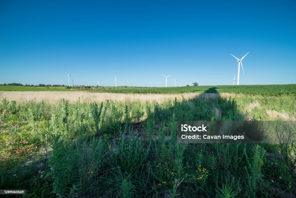 Shadow of a modern wind mill on the countyside near a wind mill farm Shadow of a modern wind mill on the countyside near a wind mill farm in Tarariras, Colonia Department, Uruguay Uruguay Stock Photo