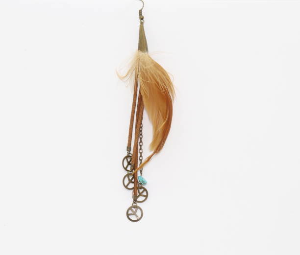 istock earring with feather and peace symbol 1289062438
