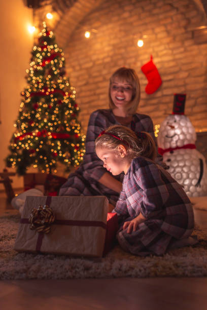 istock Mother and daughter opening Christmas presents 1289062611