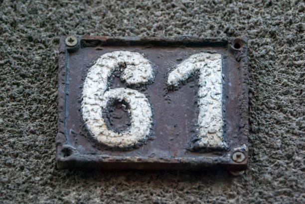 istock Old retro cast iron plate number 61 1289063634