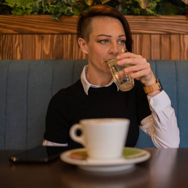 istock Woman drinking water at the coffee shop 1289068702