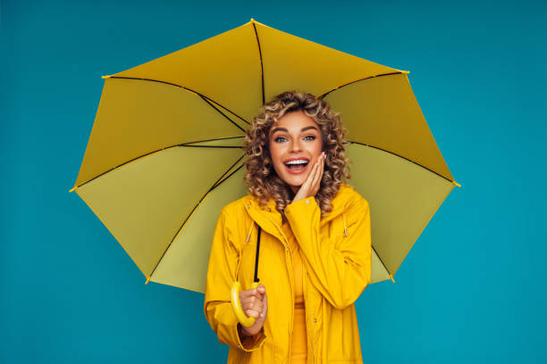 istock Girl with yellow umbrella 1289069313