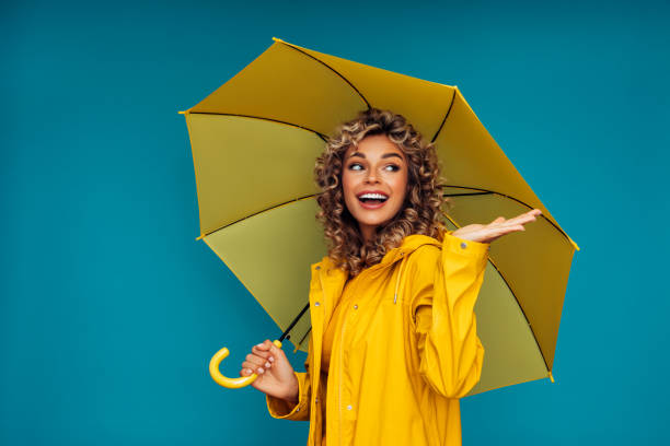istock Girl with yellow umbrella 1289069324