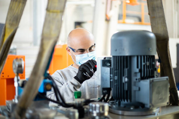 istock Senior worker in the factory operating machines 1289070614