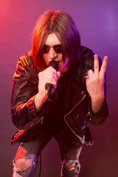 istock rock musician singing in microphone 1289070643