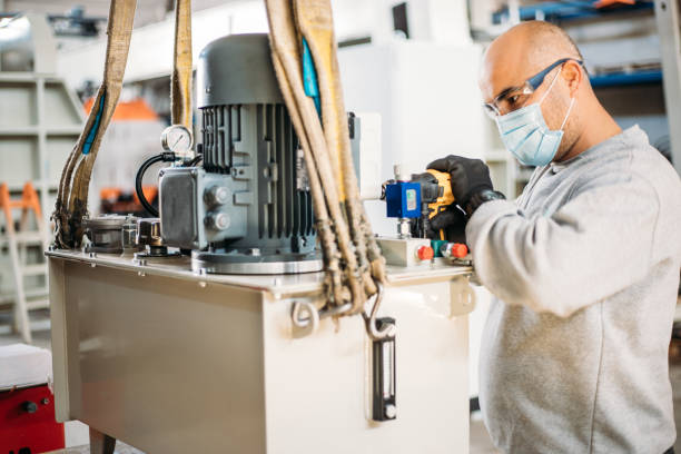 istock The worker with helmet and protect glasses is using a drill 1289071357
