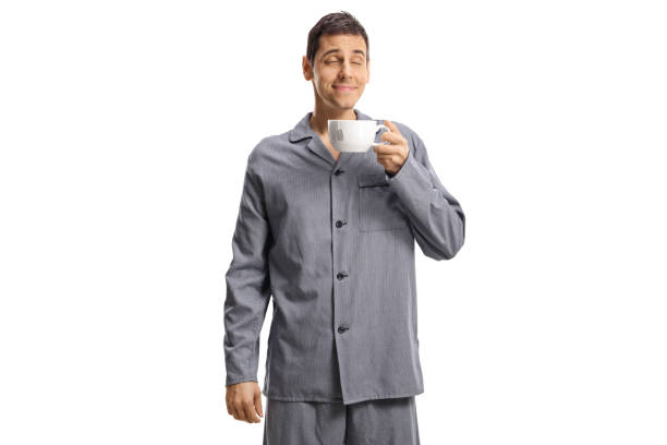 istock Young man in pajamas enjoying a cup of tea 1289073077