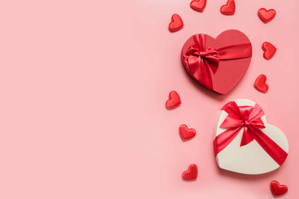 istock Valentine's Day concept with red boxes and hearts on pink. 1289073487