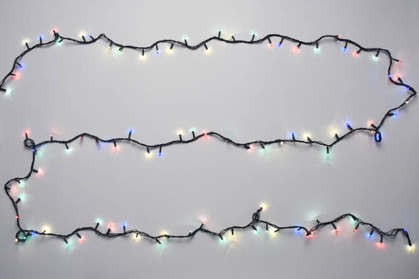istock Christmas lights on the white background 1289074583