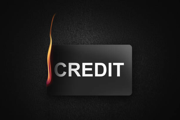 istock burning credit card on black background 1289074708