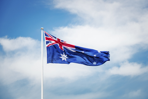 An image of the australian national flag in front of the sky