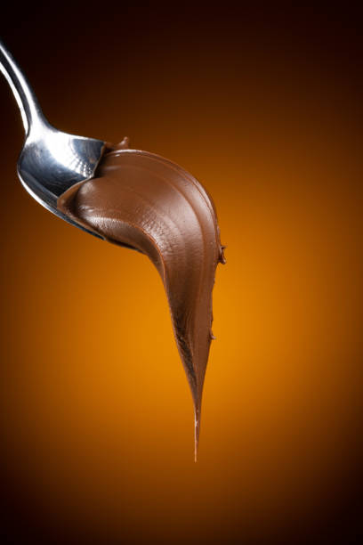 istock Cream chocolate in spoon on dark background 1289074807