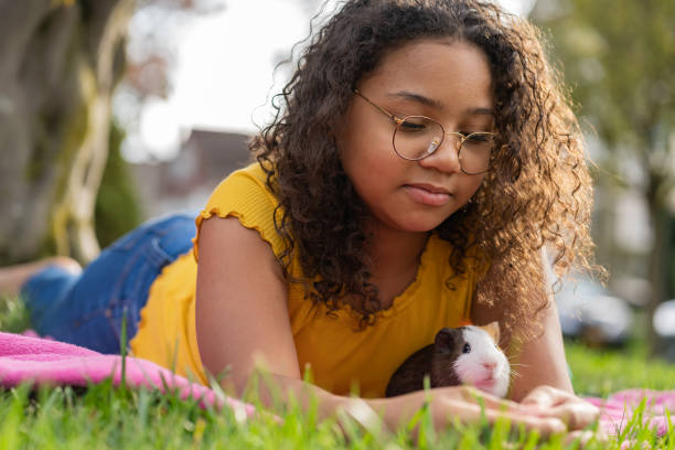 Black girl holding her new pet outdoors stock photo
