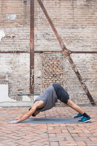 istock Stress Relief after Work: A Young Man Doing Yoga in his Backyard 1289077188