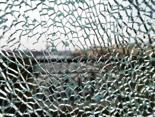 Photo of toughened glass in the cracks behind the bridge fence.