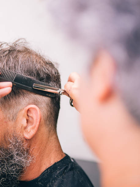 istock Closeup Man Getting Haircut 1289077529