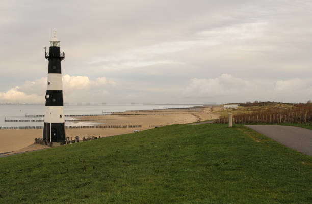 istock dutch coastal landscape with a lighthouse and dunes along long beaches 1289077641
