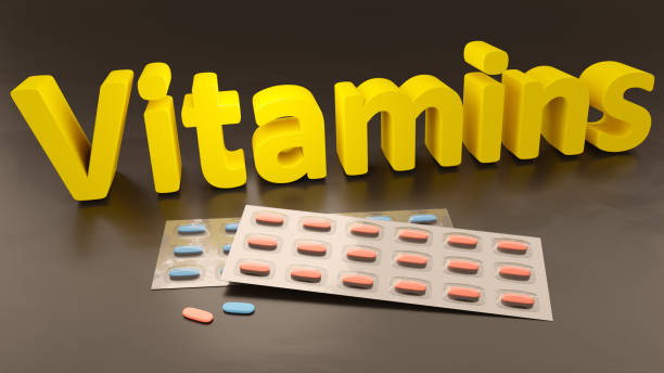 istock the word vitamins and some pills 1289078789