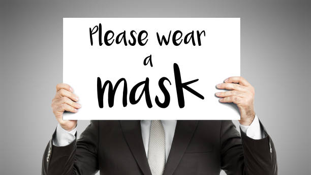 istock business man message Please wear a mask 1289078815