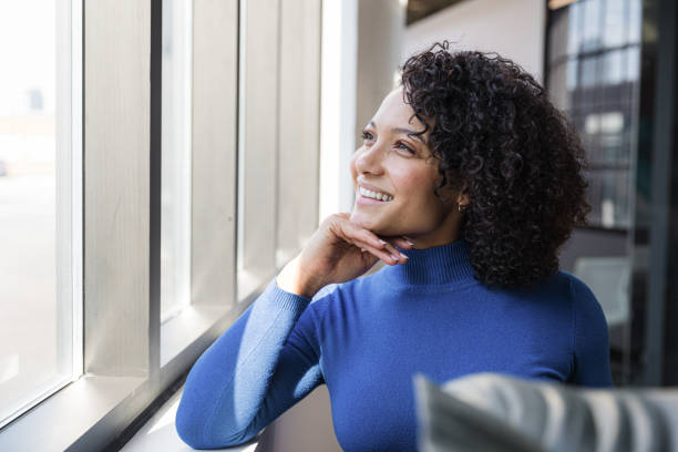 istock Young Mixed Race Woman by the Window 1289079964