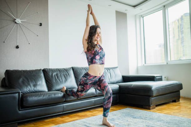 istock Young fit woman practicing at home 1289080098