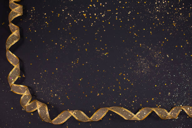 istock gold bronze metallic ribbon on glitter background 1289080787