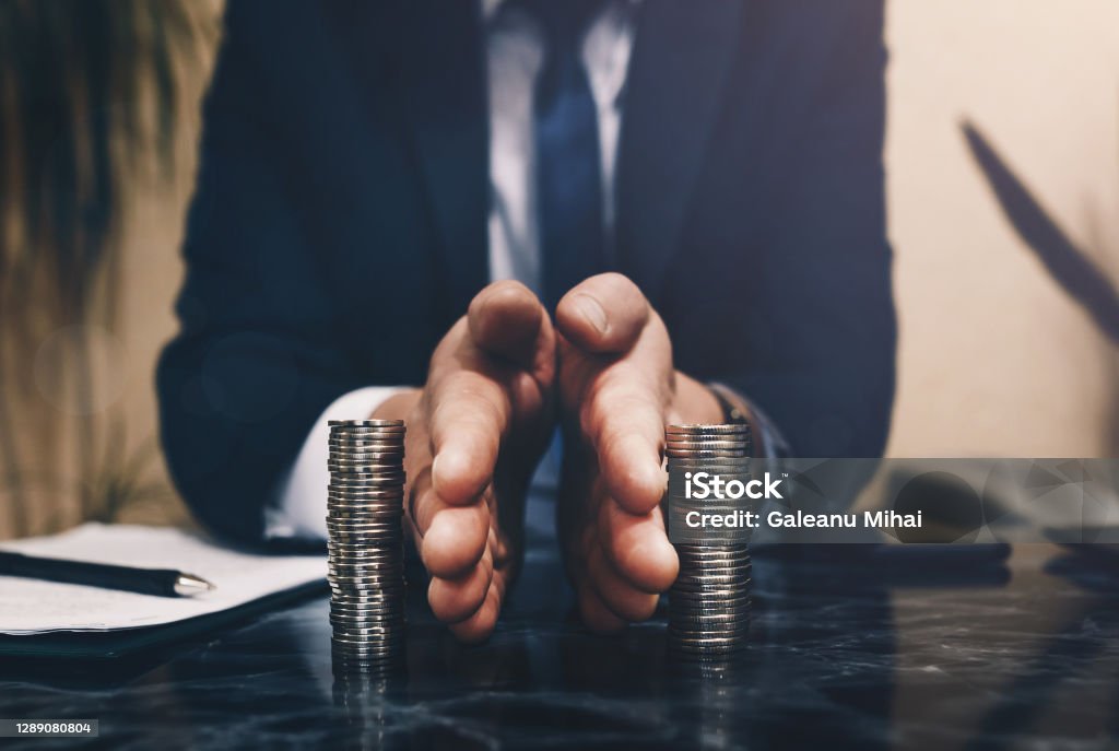 Businessman separates stack coins. Concept of  saving and investing.  Property division. Divorce and legal services. Businessman separates stack coins. Concept of  saving and investing.  Property division. Divorce and legal services Divorce Stock Photo