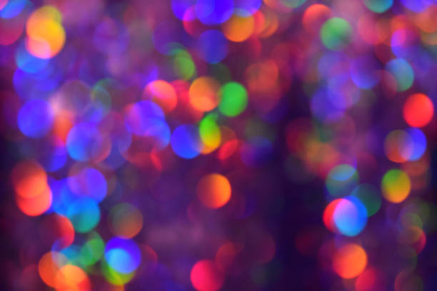 istock Christmas background, garland in blur. Glowing and festive rainbow light circles created in camera and bokeh lens. Christmas fairy lights are defocused giving a blurry effect. 1289081032