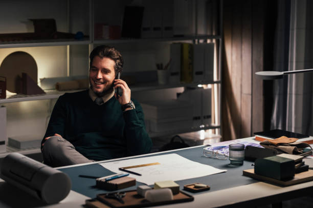 istock Smiling Young Civil Engineer Talking on the Phone in his Office 1289083437