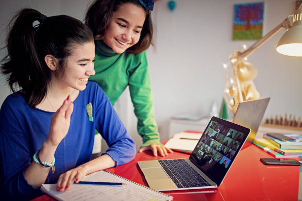 istock Two sisters are e-learning and video conferencing at home 1289084506