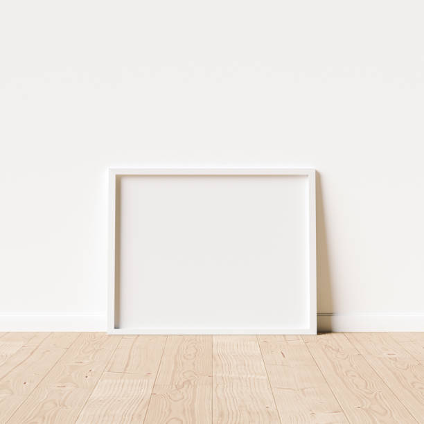 istock 10x8 White Mockup Frame positioned on wooden flooring 1289086913