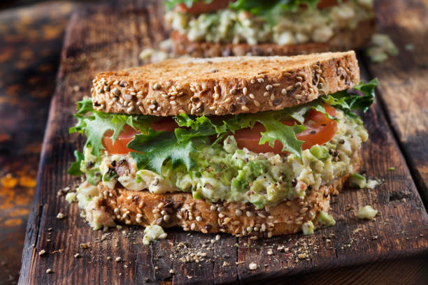 istock Avocado and Egg Salad Sandwich with Crispy Bacon, Lettuce and Tomato 1289087861