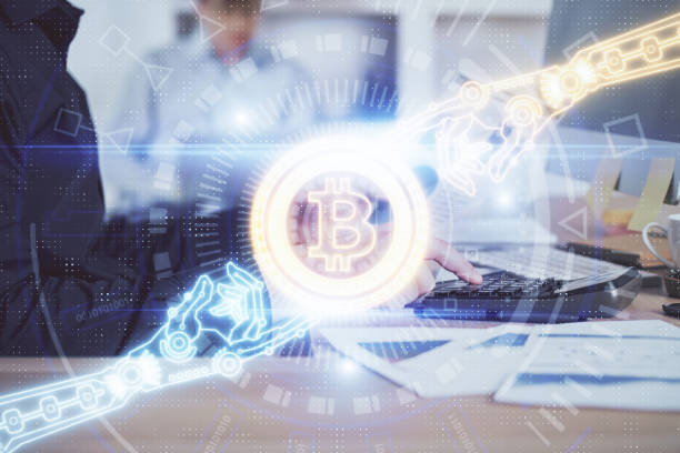 istock Crypto currency theme hologram with businessman working on computer on background. Concept of blockchain. Multi exposure. 1289088077