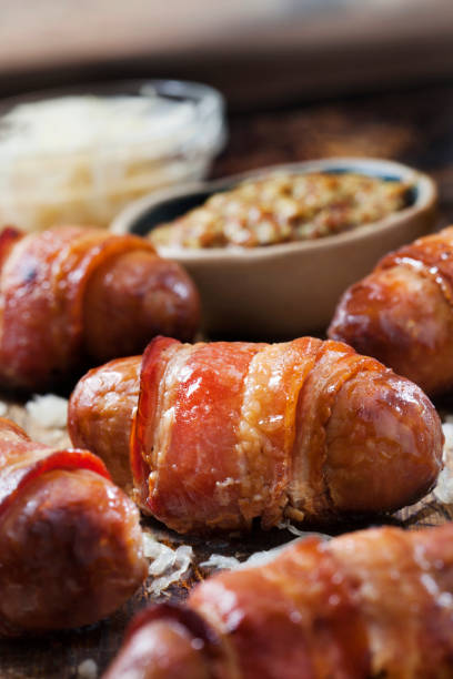 istock Mini Bacon Wrapped Bratwurst Sausages with  Sauerkraut and Grainy Mustard 1289088659