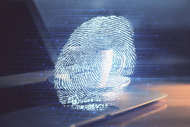 istock Computer on desktop in office with finger print drawing. Double exposure. Concept of business data security. 1289088714