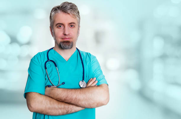 istock Smiling doctor with crossed arms looking at camera 1289088782