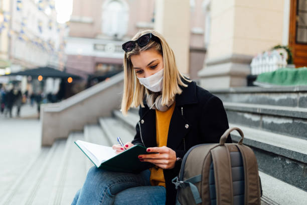 istock Beautiful Caucasian female student wearing a face mask 1289088963