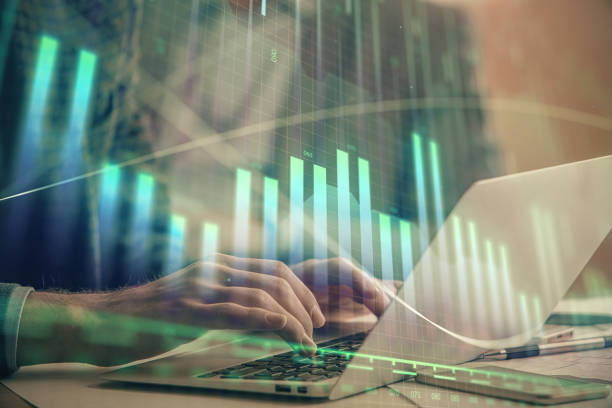 istock Double exposure of market chart with man working on computer on background. Concept of financial analysis. 1289089105