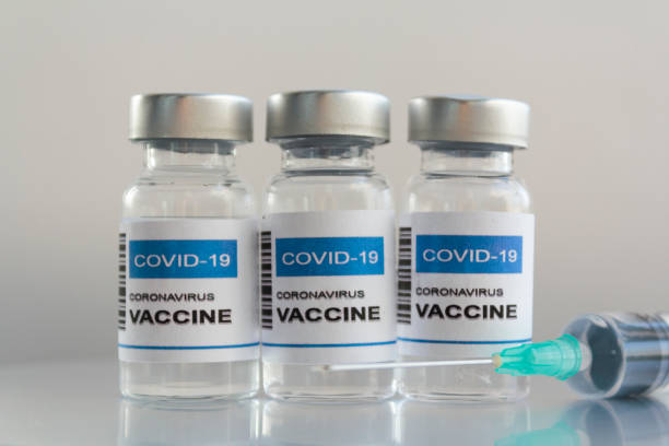 istock Injection Vials with Covid-19 coronavirus vaccine and syringe 1289089243