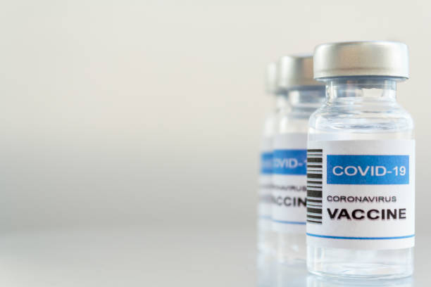 istock Injection Vial with Covid-19 coronavirus vaccine. White background with copy space 1289089255